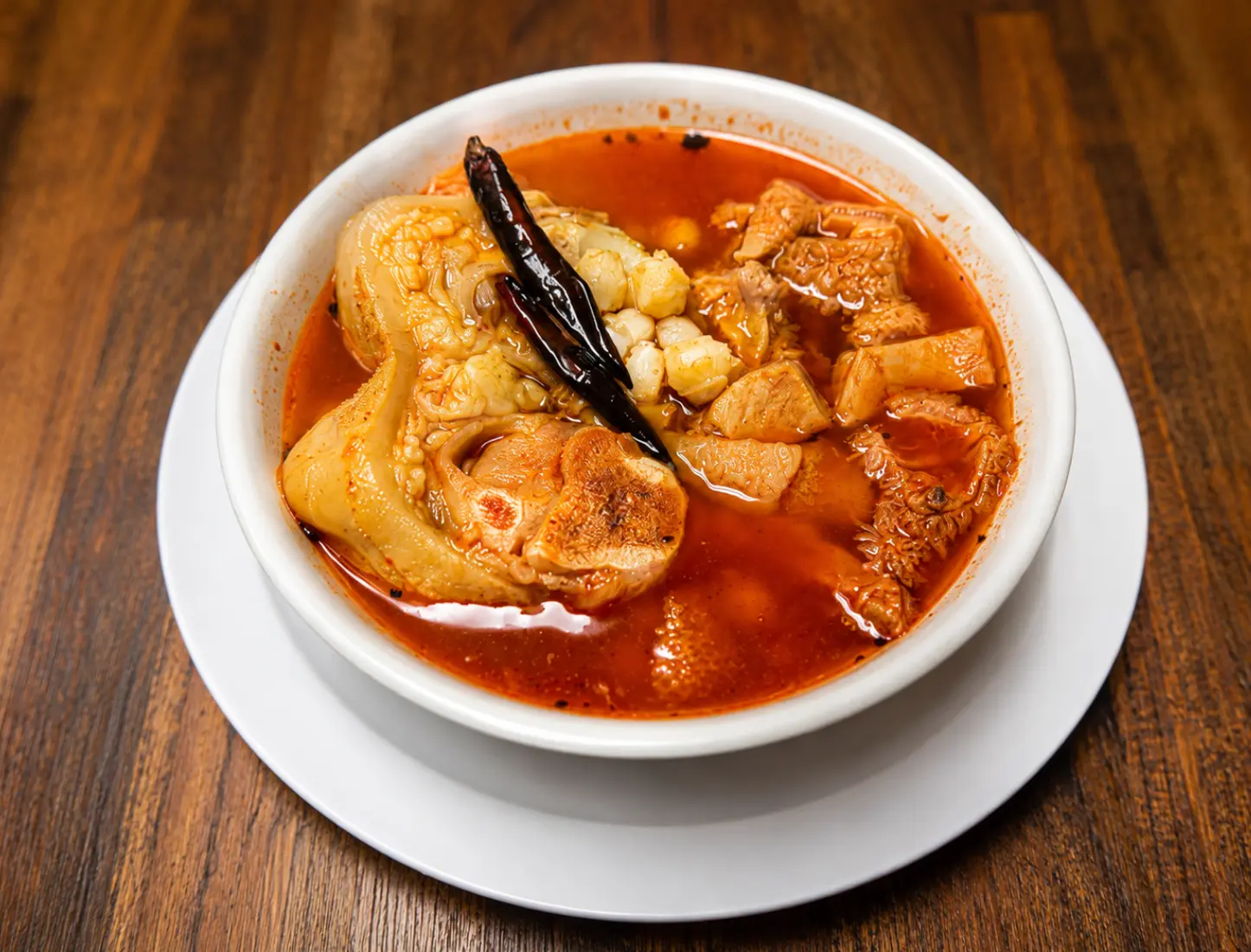 Bowl of menudo with hominy and chile de árbol