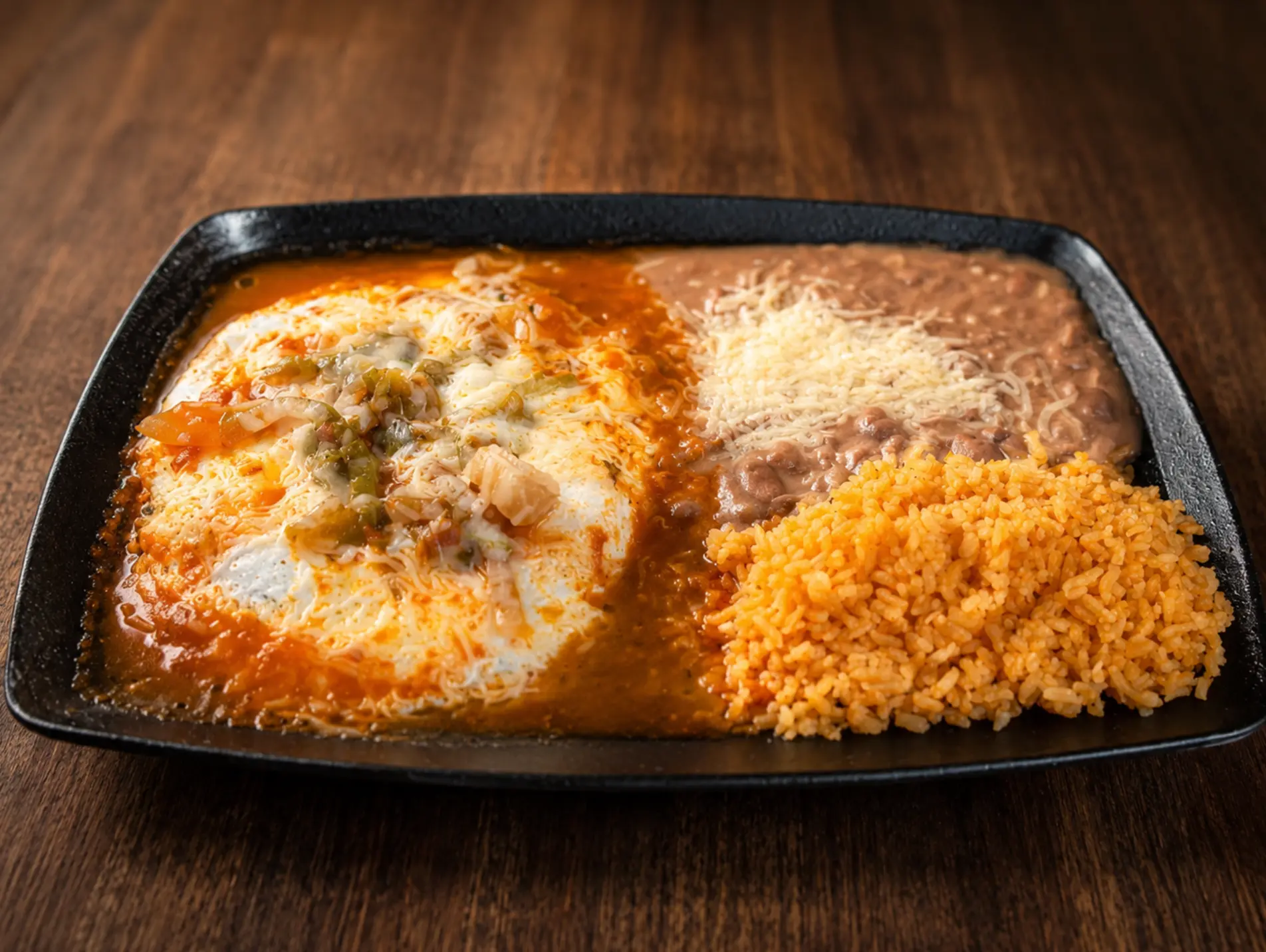 Huevos rancheros with rice and refried beans